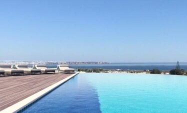 Infinity pool at Longevity Hotel Algarve overlooking the Atlantic Ocean in Portugal.