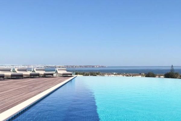 Infinity pool at Longevity Hotel Algarve overlooking the Atlantic Ocean in Portugal.