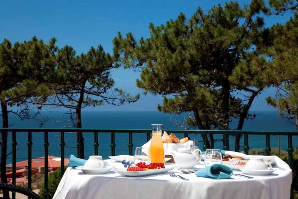 Healthy breakfast overlooking ocean at Portugal luxury retreat.