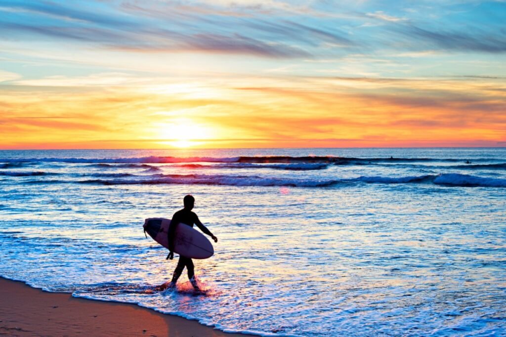 Surfer catching a wave at sunset in Portugal