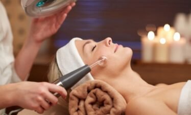 Professional esthetician giving facial spa treatment at wellness retreats portugal