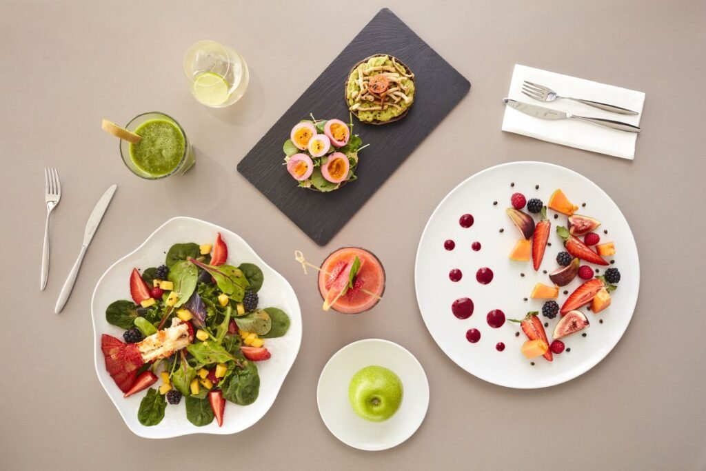 Assortment of healthy wellness cuisine with salads and smoothies.