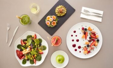 Assortment of healthy wellness cuisine with detox salads and smoothies.