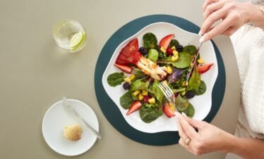 Fresh salad dish with greens and strawberries.