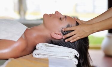 Relaxing head massage therapy at luxury spa.