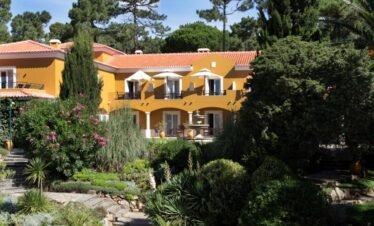 Luxury yellow villa in Cascais, Portugal wellness retreat.