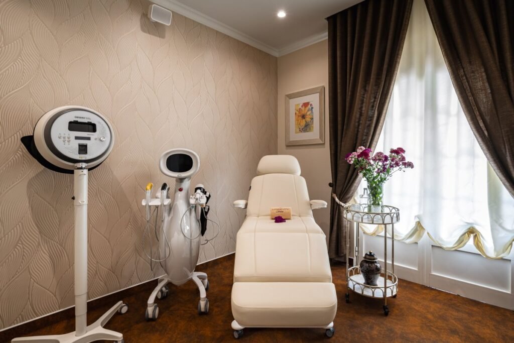 Spa treatment room with massage bed and medical equipment.