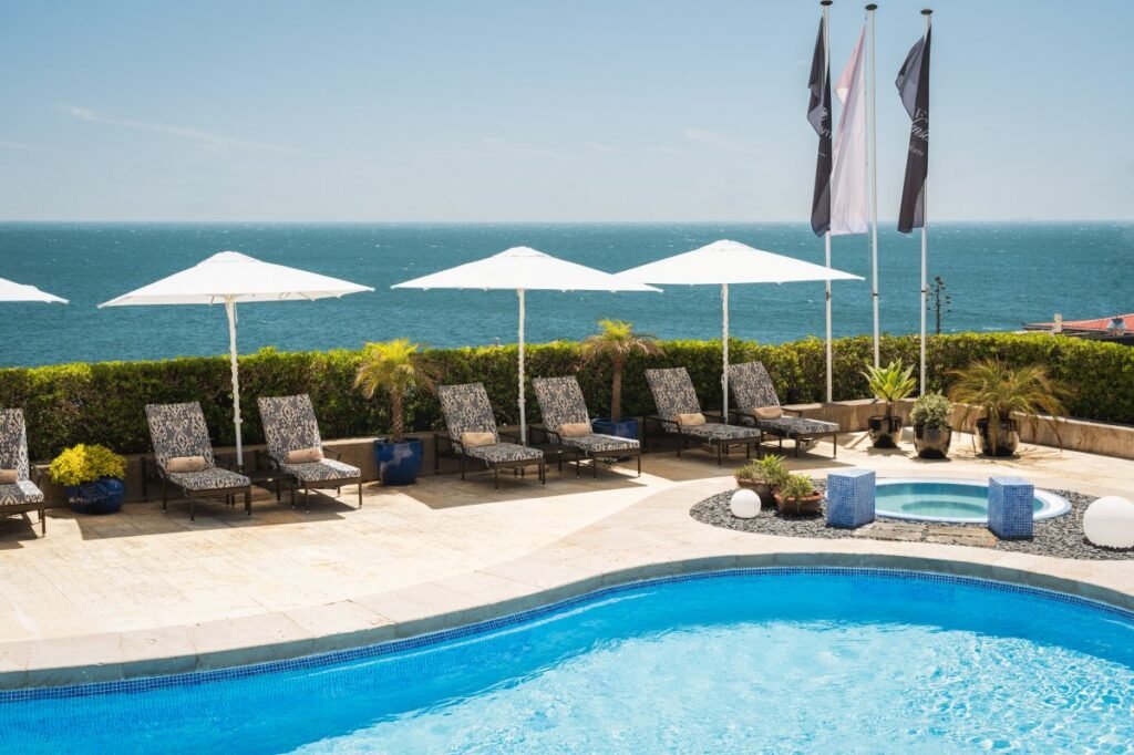 Resort swimming pool with umbrellas at Portugal luxury spa.