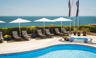Resort swimming pool with umbrellas at Portugal luxury spa.