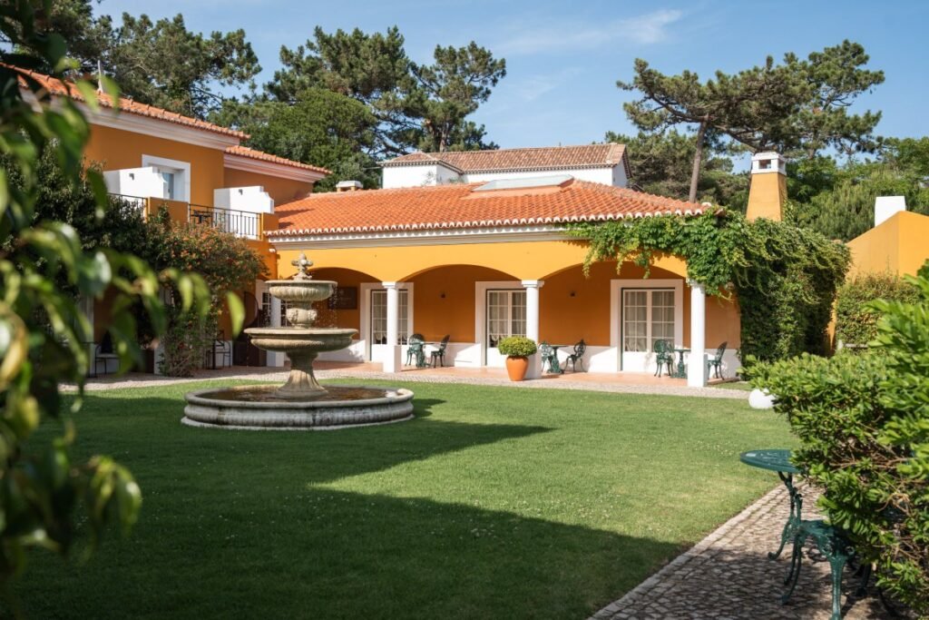 Luxury villa with spacious lawn at Portugal wellness retreat.